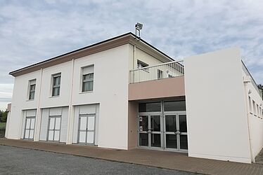 Salle polyvalente: extérieur du bâtiment de couleur beige